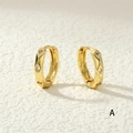 Close-up of gold huggie earrings featuring embedded zircons and a hinged clasp mechanism - White Zircon / White
