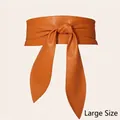 Elegant plus size wide waist belt in bright orange faux leather with front bow tie design - Plus Size / Brown