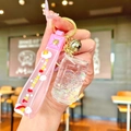 Pink unicorn liquid sand keychain with glitter, PVC strap, and golden bell detail - White Luminous Cola Can