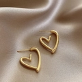 Elegant gold heart-shaped stud earrings displayed on premium champagne satin fabric - E6034 Gold Hollow Heart