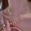 Elegant gold bow necklace with shimmering zircon stones worn on woman neck - Rhinestone Bowknot (XL05-89)