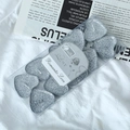 Close-up of heart-shaped silver glitter candles in a clear box for romantic occasions - Silver