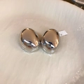 Macro shot of silver twisted bean earrings with high-polish mirror finish on a ceramic tray - Style 18# S925 Silver Pin Silver Half Oval Studs