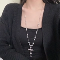 Elegant long pearl necklace featuring a sparkling rhinestone cross pendant on a model - Rhinestone Cross Artificial Pearl Necklace (X4586) / Silver