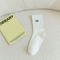 White cotton crew sock with small black eye embroidery on a soft fleece background - Blue Eye with Lashes / White (Big Eyes)