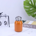 Mini orange stainless steel insulated pocket cup with metal ring cap on marble surface - 300ml (316 Base) / Orange