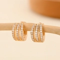 Detail of four-row zircon hoop earrings hanging on a natural wooden branch display - EH215 Four Layer Zirconia
