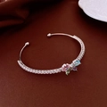 Detail of silver butterfly cuff bracelet with colorful zircons on dark silk - Multicolor Butterfly Style / Silver