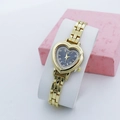 Detail of heart-shaped gold quartz watch with blue crystal dial on display stand - Black