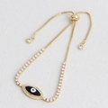 Detail of gold evil eye bracelet with blue stones and adjustable sliding box chain - Black
