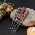 Detailed view of handmade moon hair comb with raw pink crystals on a stone background - Strawberry Quartz