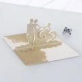 Macro shot of 3D wedding card with gold glitter Mr & Mrs silhouette and rings detail - Light Gold Glitter