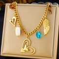 Close-up of gold wing and heart charms with brown tiger eye beads on a choker necklace - Heart Wing Blue Crystal Beaded Style (N3264)