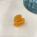 Close-up of a small orange acetate hair claw with France Handmade print details - 2.6cm / Jelly Orange
