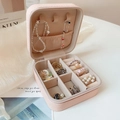 Detail view of pink travel jewelry organizer with multiple storage slots for rings and earrings - Pink