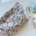 Détail d'une trousse à maquillage en coton à fleurs avec étiquette 'simple wish' cousue - Petites roses rouges
