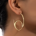Polished gold chunky spiral C-shaped earrings showing elegant ear styling for women - Gold