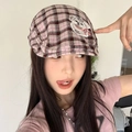 Close-up of pink and grey plaid beret hat with a cute cartoon dog embroidery detail - Pink Puppy Patch Plaid