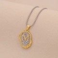 Detailed view of an irregular gold pendant with 'M' engraving and inlaid diamonds - Letter M