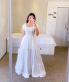 Detail of white off-shoulder floral maxi dress featuring puff sleeves and tiered skirt - S / White
