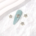Golden alloy five-point star nail art charms with sparkling crystals on light blue nails - Gold White Zirconia
