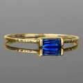 Detail of gold hammered texture ring featuring a baguette cut deep blue gemstone - US 5 / Blue