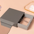 Gray slide jewelry gift box with transparent PE film showing a purple gem necklace - Hard-sided Small Plaster Box; 7*7*2