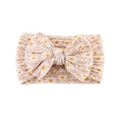 Close-up of beige baby headband with white daisy print and soft ribbed knit texture - Beige Daisy