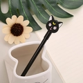 Cute black cat neutral pen with yellow moon charm in a white ceramic pencil holder - Black Barrel Black Cat