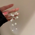 Eleganti orecchini mughetto con perle bianche e nappe dorate su uno sfondo caldo e neutro - Gancio per Orecchio-Bianco