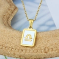 Gold stainless steel Libra zodiac necklace with square shell pendant on stone display - Libra