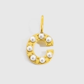 Detailed view of a gold-plated letter C pendant with elegant inlaid round pearls - Gold-C