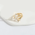 Minimalist open ring in dual gold and silver finish on a white display stand - Smiley Face / Gold and Silver