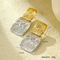 Macro shot of geometric two-tone earrings with textured gold and silver rectangular drops - Gold Silver Contrast Ripple Rectangle Splicing (NMSE-C337-2)