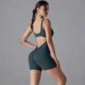 Detail of dark teal yoga bodysuit featuring a U-shaped back cut and scrunch butt design - Wood Green