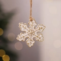Macro detail of a white and gold snowflake resin ornament with a natural jute rope hanger - Style 11 (White Snowflake)