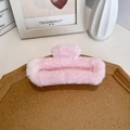 Chic pink plush faux fur claw clip for thick hair displayed on a wooden tray - Light Pink