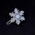 Rotating snowflake brooch pin with cubic zirconia crystals on a textured black background - Silver Snowflake Hair Clip