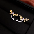 Close-up of a silver dragonfly earring with yellow, purple, and white stones on black velvet - Yellow Zirconia Dragonfly (925 Silver Pin)