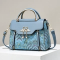 Blue embroidered handbag with contrast leather, gold swan buckle and pearl tassel - Blue
