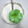 Translucent green flower hair claw clip on white decorative display stand - Green (Rolled Flower)