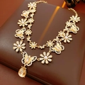 Dettaglio della collana vintage dorata con ciondoli floreali in resina, farfalle e perle - Collana a Doppio Strato con Fiori e Farfalle Dorata