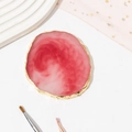 Pink resin agate nail art palette with gold rim shown with brushes and tulle fabric - Red