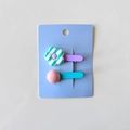 Detail of two cute flower and round bead hair clips for girls on a blue paper card - Green Stripes