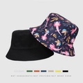 Reversible bucket hat featuring solid black side and pink axolotl pattern on dark blue - Axolotl