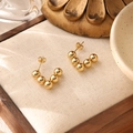 Detailed view of 18K gold plated beaded hoop earrings on a rustic linen background - Graduated Ball Hoop (ZHE479金)