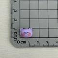 Mini purple resin cat charm with blue facial details shown on a measuring scale mat - Purple Cat
