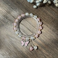 Exquisite pink beaded bracelet featuring a delicate butterfly charm on a wooden background - S024-rhinestone Butterfly Pink Bracelet With Bursting Flowers #sz208