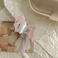 Detail view of marble pattern bat wing hair claw clip on vintage background - Pink and White Pattern
