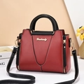 Elegant red and black contrast leather handbag with golden logo and top handle for women - Red & Black
